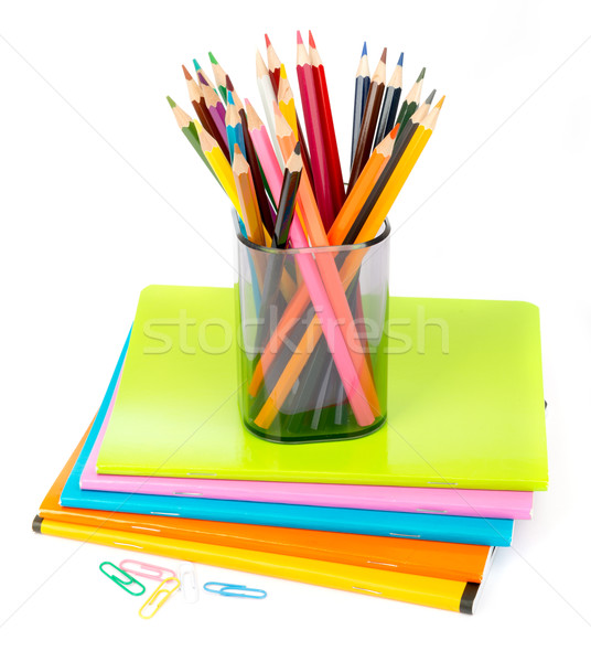 Pencil cup with crayons and clips on copybooks Stock photo © cherezoff