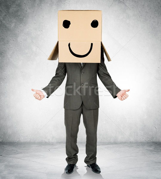 Businessman with box on head and smiley face Stock photo © cherezoff