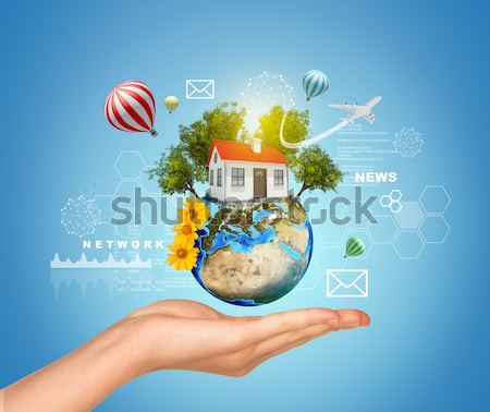 Earth with clouds above humans hands Stock photo © cherezoff