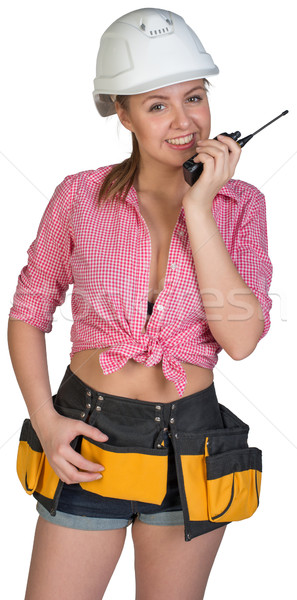 Woman in hard hat and tool belt talking on radio Stock photo © cherezoff
