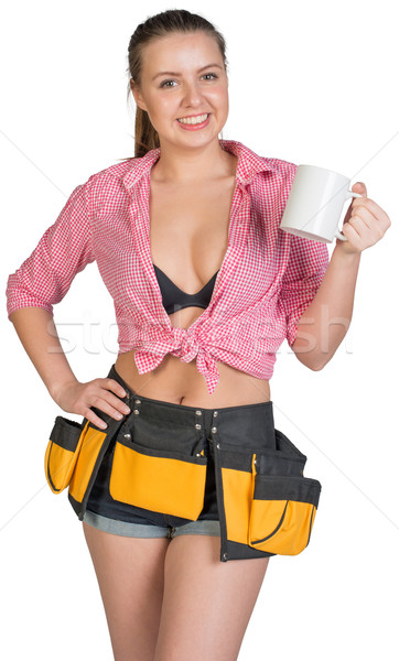 Woman in tool belt showing white mug Stock photo © cherezoff
