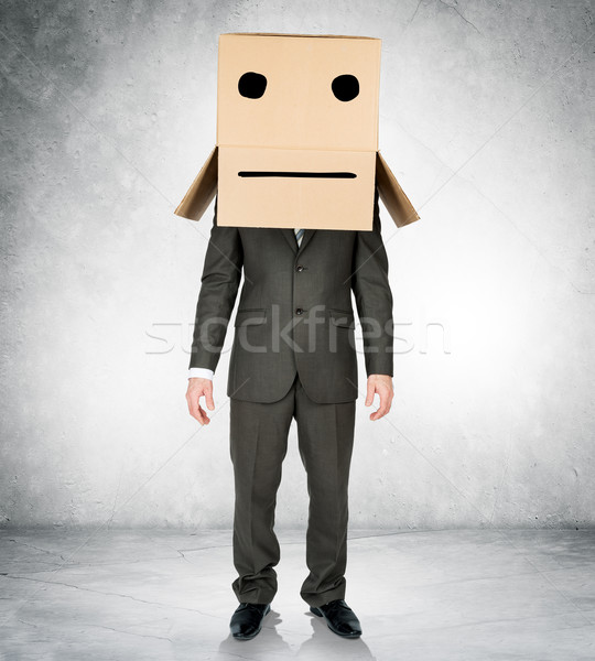 Businessman wearing carton box with drawn emotions Stock photo © cherezoff