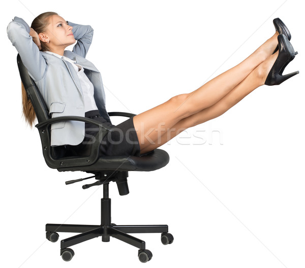 Businesswoman on office chair with her feet up Stock photo © cherezoff