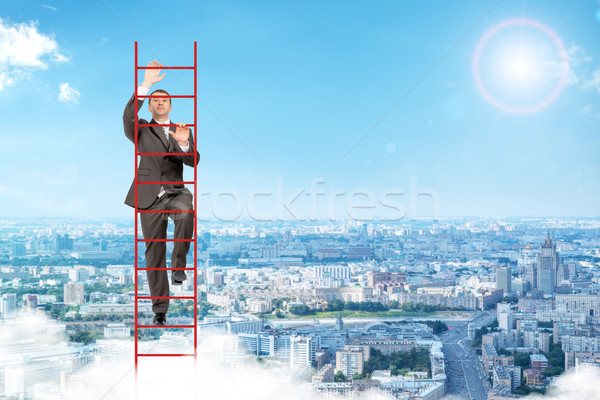 Businessman climbing red  ladder in sky Stock photo © cherezoff