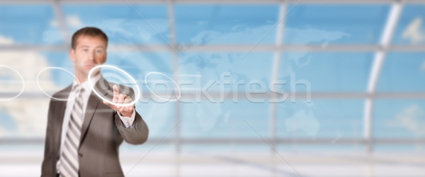 Businessman pressing on holographic screen Stock photo © cherezoff