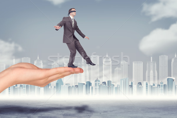 Businessman walking from edge of hand Stock photo © cherezoff
