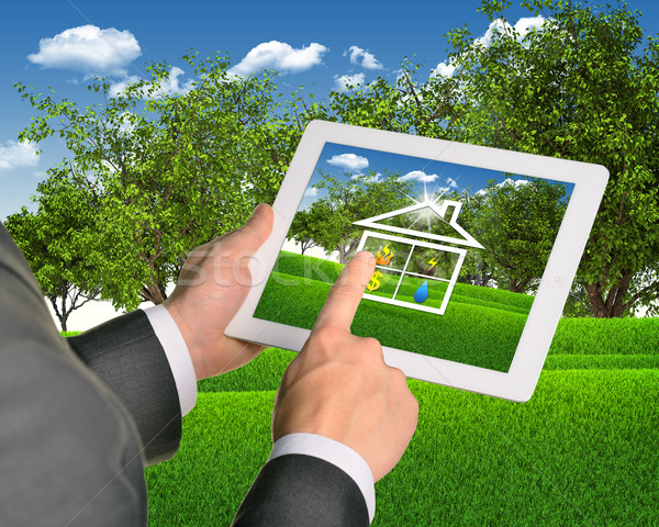 Man using tablet with symbols of public service and house Stock photo © cherezoff