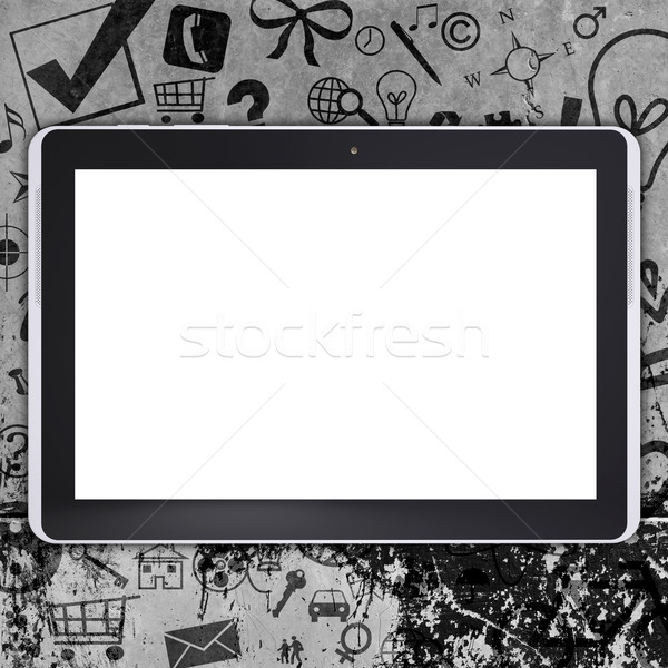Tablet pc on concrete floor with various social icons Stock photo © cherezoff