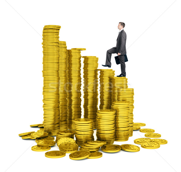 Businessman walking on gold coins piles Stock photo © cherezoff