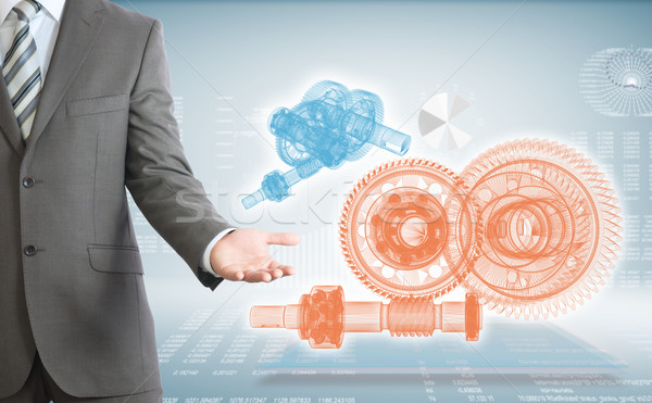 Businessman points hand on wire frame gears Stock photo © cherezoff
