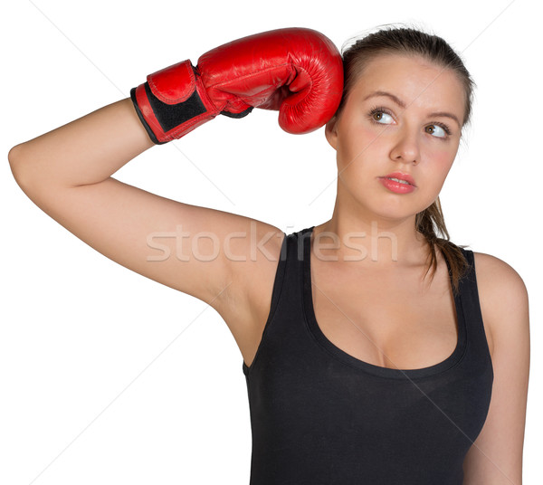 Woman holding boxing glove at her temple Stock photo © cherezoff