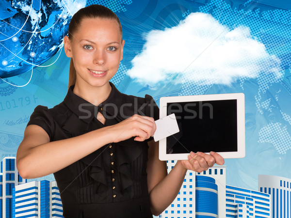 Beautiful businesswoman holding tablet PC. Globe, world map and other virtual elements as backdrop Stock photo © cherezoff