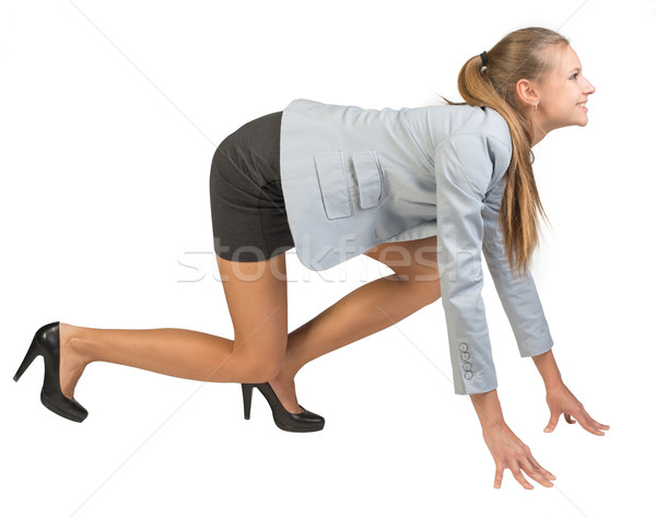 Businesswoman standing in running start pose Stock photo © cherezoff