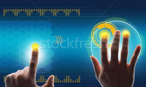 Humans hands touching blue holographic screen Stock photo © cherezoff