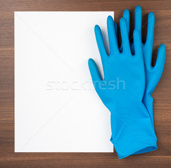 [[stock_photo]]: Papier · vierge · bleu · gants · en · caoutchouc · table · en · bois · papier · blanche