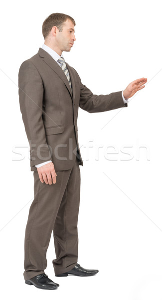 Businessman with outstretched hand, side view Stock photo © cherezoff