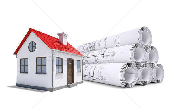 Small model house with red roof near scrolls of architectural drawings Stock photo © cherezoff