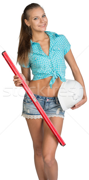 Nice sexy woman holding red building level and white helmet Stock photo © cherezoff