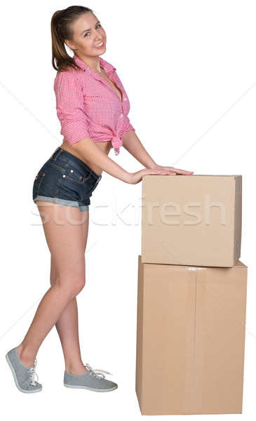 Woman leaning on stacked cardboard boxes Stock photo © cherezoff