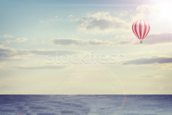 Concrete floor on background of clouds, sun with air balloon Stock photo © cherezoff