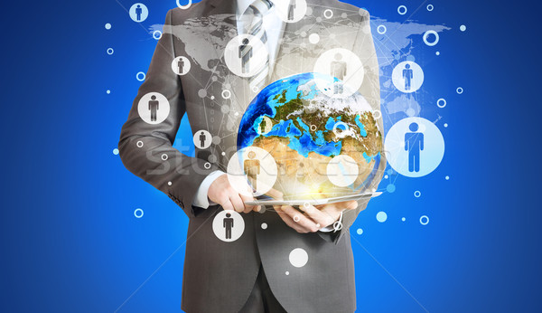 Businessman hold tablet pc, Earth and contacts Stock photo © cherezoff