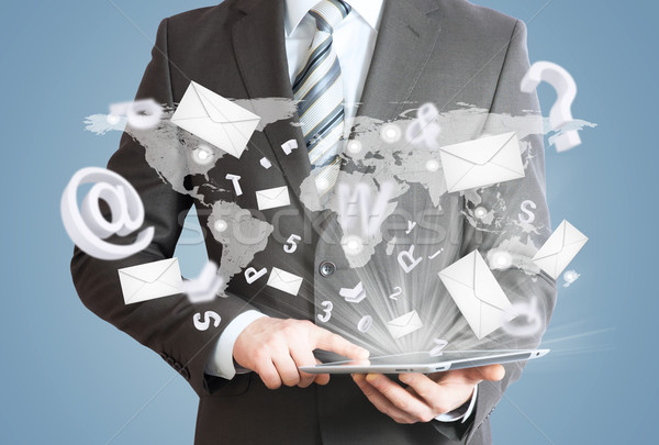 Man in suit holding tablet pc. Mailing concept Stock photo © cherezoff