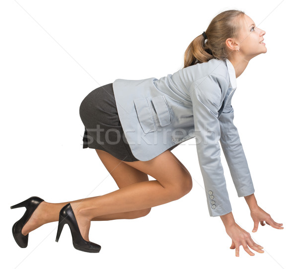 Businesswoman standing in running start pose Stock photo © cherezoff