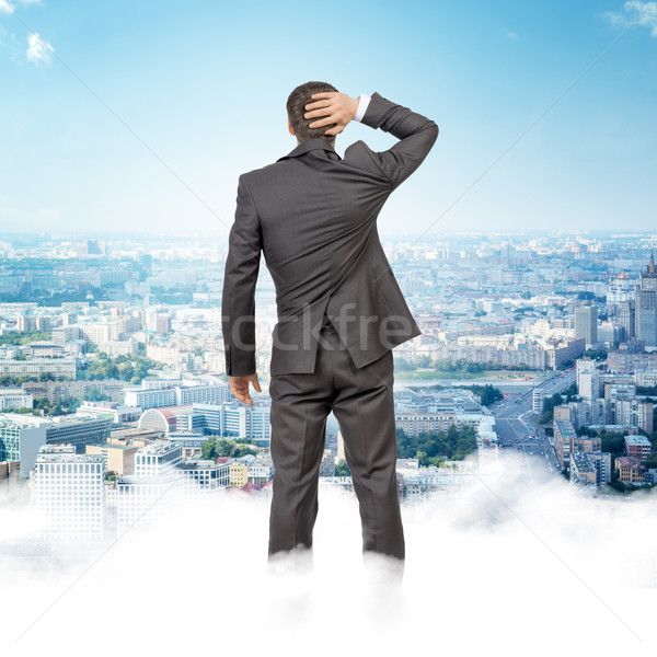 Homme permanent nuages ciel regarder ville [[stock_photo]] © cherezoff
