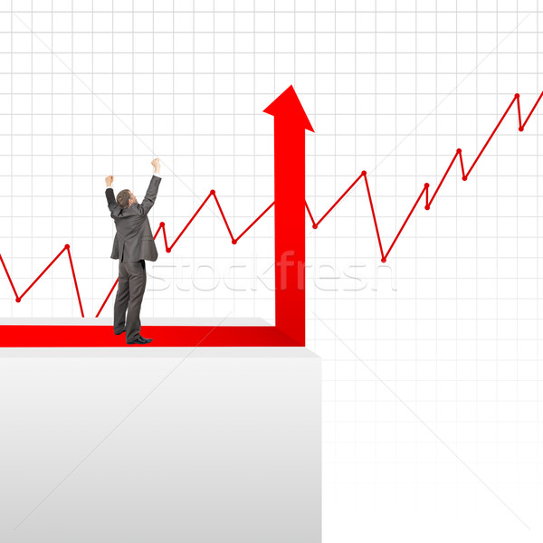Happy businessman standing on edge of chart Stock photo © cherezoff