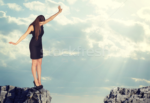 Businesswoman standing on the edge of rock gap Stock photo © cherezoff