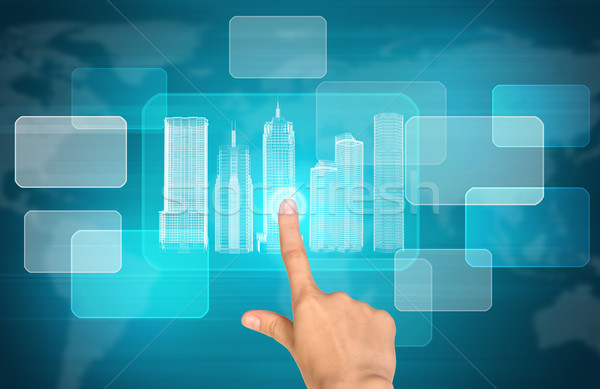 Humans hand pressing on virtual city model Stock photo © cherezoff