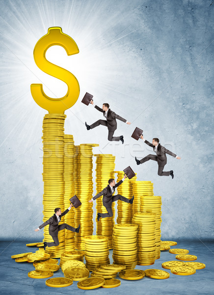 Businessmen run and jump on money stairs  Stock photo © cherezoff
