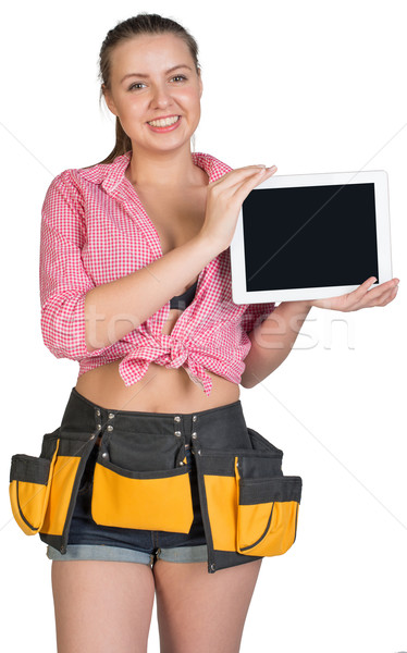 Woman in tool belt showing tablet PC with blank screen Stock photo © cherezoff