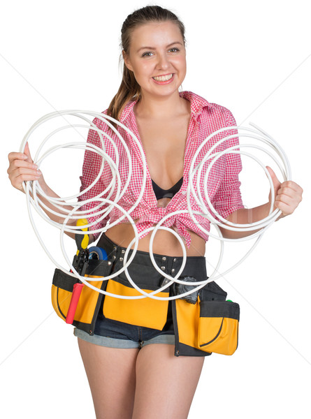 Woman in tool belt holding coils of cable Stock photo © cherezoff