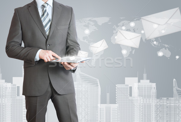 Man in suit holding tablet pc Stock photo © cherezoff