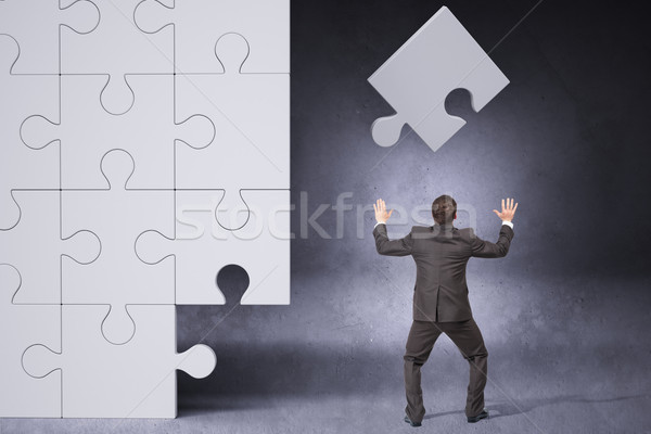 Businessman throwing on puzzle piece Stock photo © cherezoff