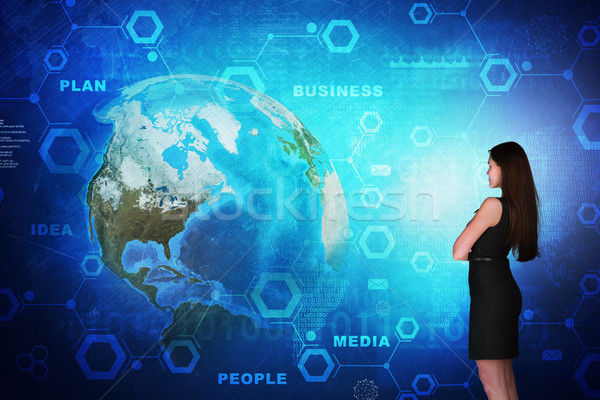 Business woman in front of holographic screen Stock photo © cherezoff