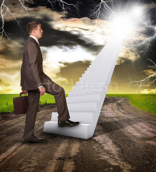Businessman climbing up stairs leading to sky Stock photo © cherezoff