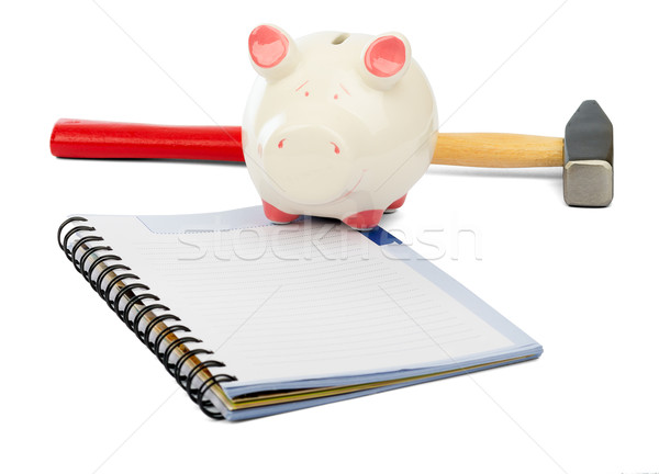 Piggy bank with hammer and pad on white Stock photo © cherezoff