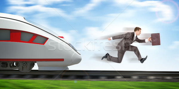 Businessman running away from train Stock photo © cherezoff