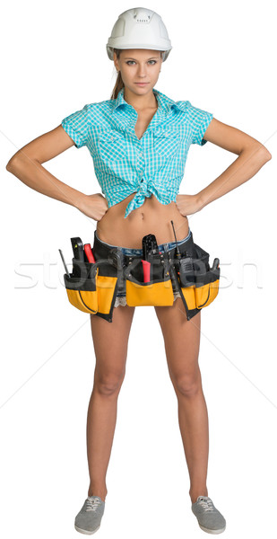 Pretty girl in helmet, shorts, shirt and tool belt with tools. Full length Stock photo © cherezoff
