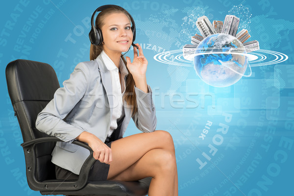 Stock photo: Businesswoman in headset and Globe