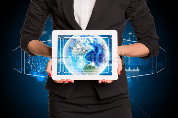 Businesswoman using tablet pc. Image of Earth on screen Stock photo © cherezoff