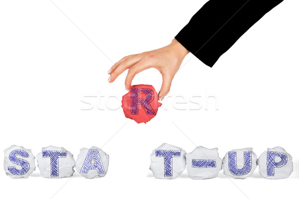 Hand holding crumbled paper ball with letter Stock photo © cherezoff