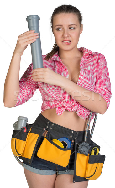 Woman in tool belt holding fitting pipe Stock photo © cherezoff