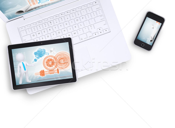 Stock photo: Tablet on laptop and mobile phone near, top view