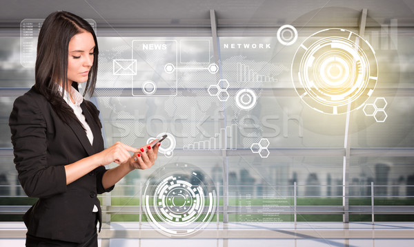 Young woman profile holding mobile Stock photo © cherezoff
