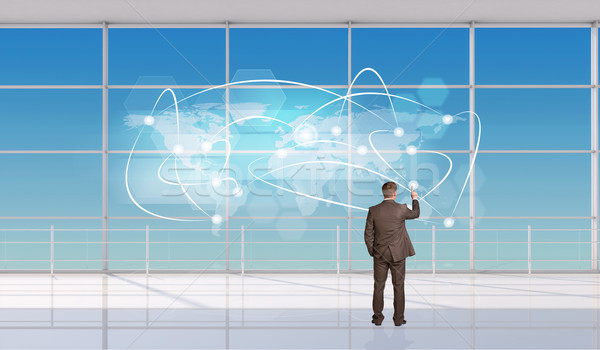 Businessman touching holographic screen Stock photo © cherezoff