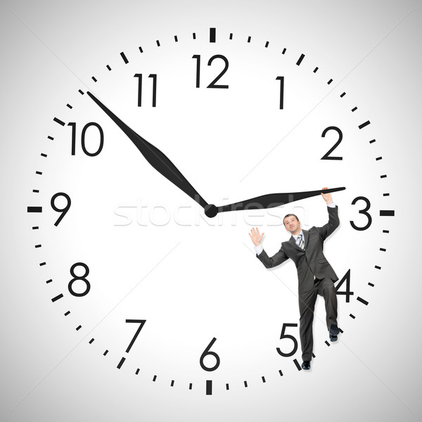 Businessman pushing clock hand Stock photo © cherezoff