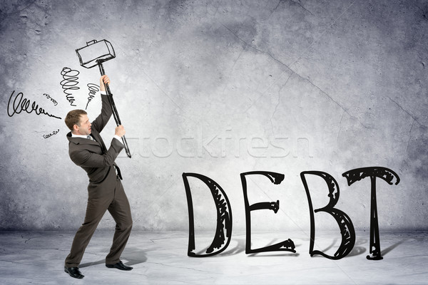 Empresario martillo palabra deuda gris pared Foto stock © cherezoff